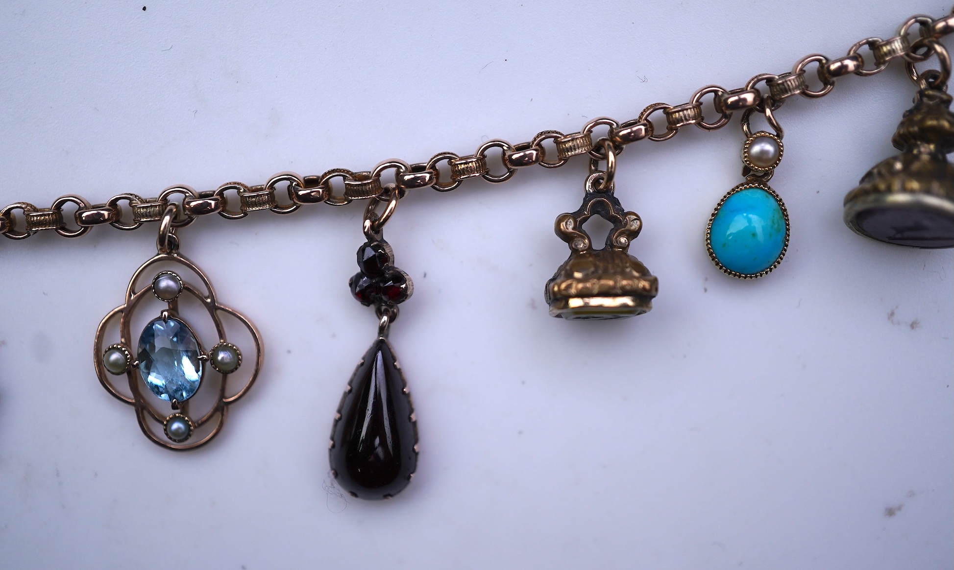A gem-set charm bracelet, late 19th-early 20th century